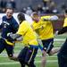 Blue Team player Mark Bihl tries to run against Maize team players during the alumni spring flag football game on Saturday, April 13. AnnArbor.com I Daniel Brenner
